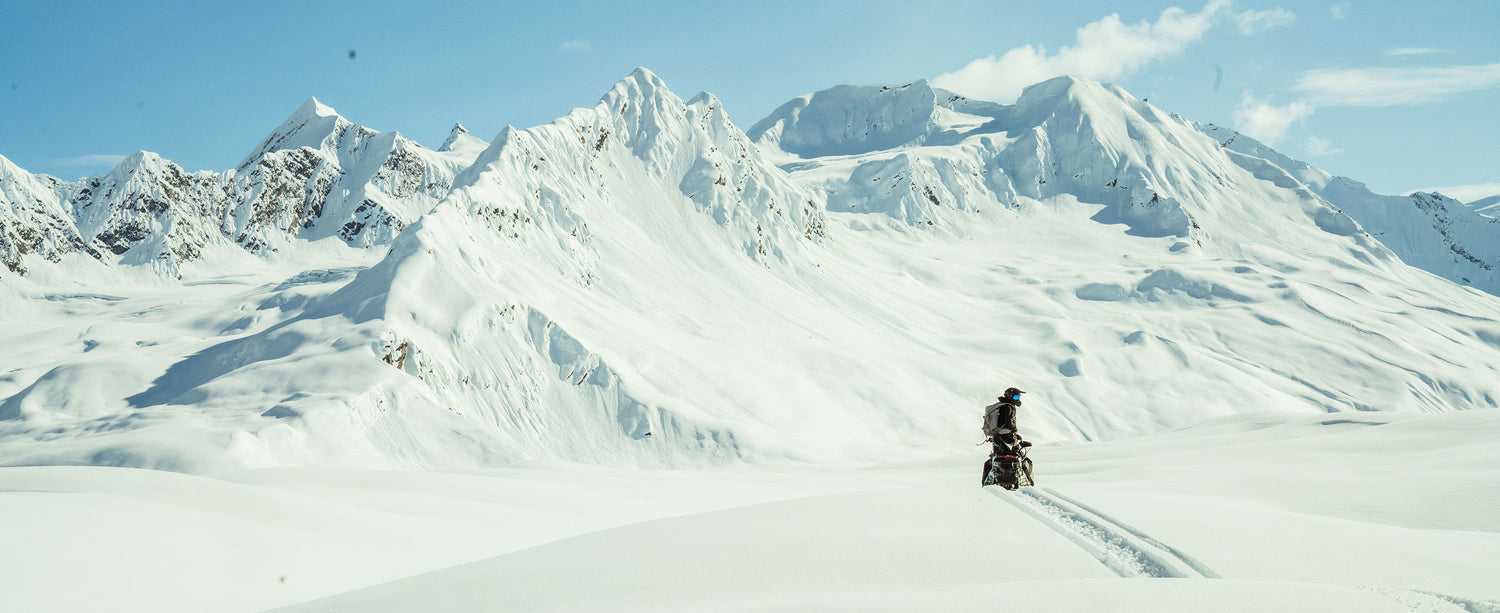 Male exploring Alaska in Obermeyer jacket with Recco avalanche radar reflector.